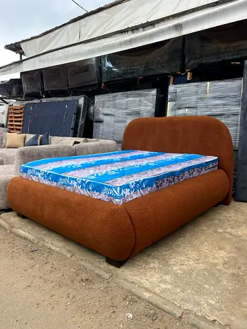 Brown Upholstered Double Bed with Curved Headboard and Base