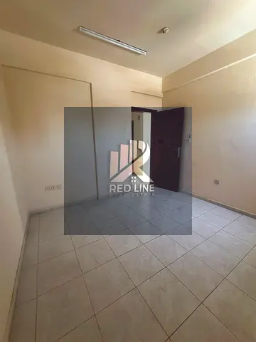 Spacious 1-bedroom apartment with a living room available for annual rent in Al Bu Tina, suitable for bachelors. The apartment is conveniently located