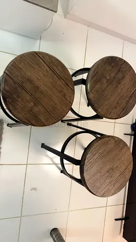 Set of three industrial style bar stools with wooden seats