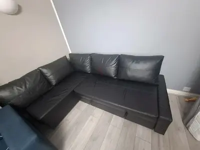 Black L-shaped faux leather corner sofa - good condition