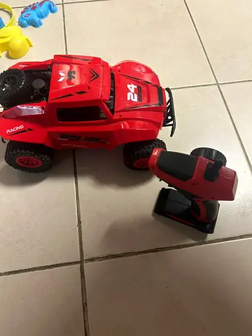 Red Remote-Controlled Off-Road Truck with Controller - Working