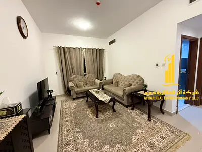 Luxury one-bedroom apartment with a balcony and open views. Ajman, Pearl Towers. Fully furnished, available for monthly rent.