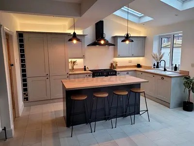 Modern Grey Kitchen Island with Bar Stools and Built-in Storage