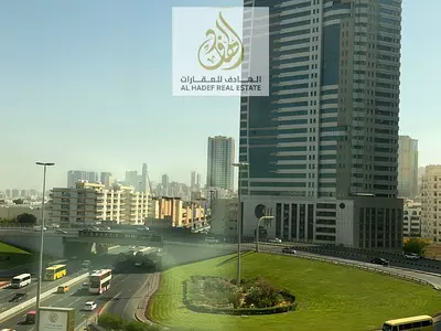 Two bedrooms and a living room with a large hallway, panoramic windows throughout, in Bushgara, Al Wahda Street, first exit directly to Dubai, built-i