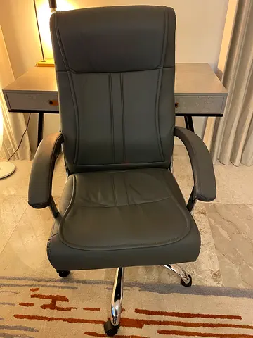 Grey faux leather swivel office chair with chrome base