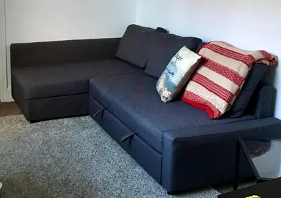 Dark grey L-shaped Sofa-bed with storage - good condition