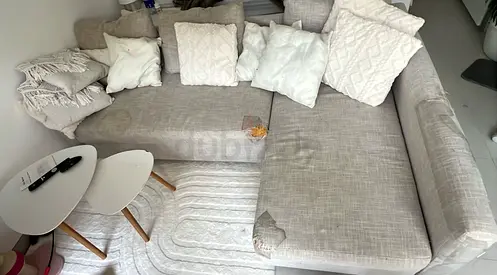 Light beige L-shaped fabric sofa with cushions (used, some wear) with storage