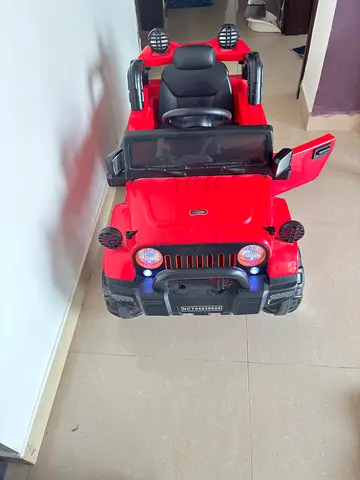 Red Ride-On Electric Jeep for Kids with Lights and Doors