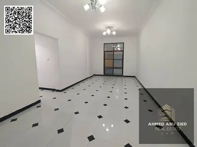 For annual rent in Al Rawda 3, Ajman: a two-bedroom apartment with a living room, spacious areas, central air conditioning, and a prime location close