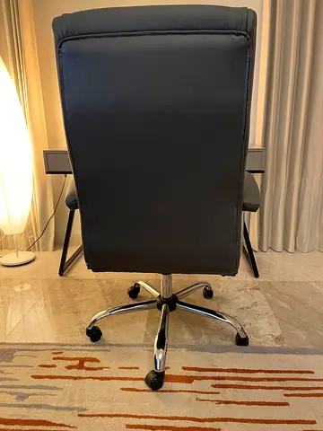Grey faux leather swivel office chair with chrome base