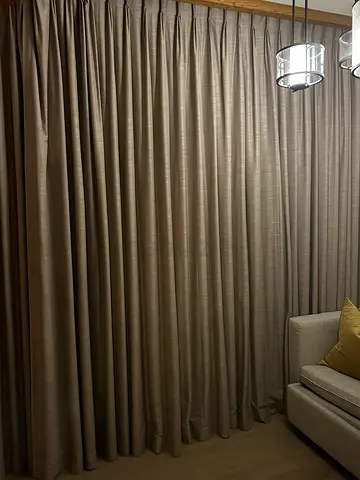 Light grey floor-to-ceiling blackout curtains . Premium quality