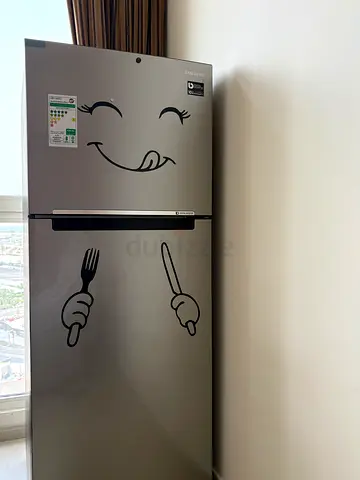 Silver double-door refrigerator in good condition