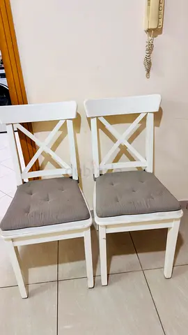 Pair of white wooden dining chairs from ikea