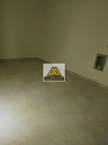 For rent: studio in Corniche, Al Karama Street, second row, very large space, semi-separated kitchen, 18k, 4/6 payments, prime location near services