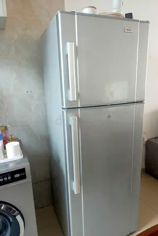 Silver double-door refrigerator in good working condition
