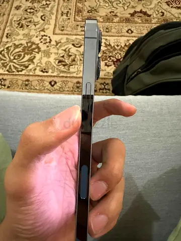 iPhone 13 Pro Max with stainless steel frame — good physical condition (side view shown)