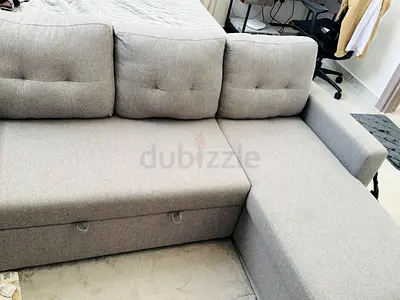 Light grey L-shaped fabric sofa with storage - good condition