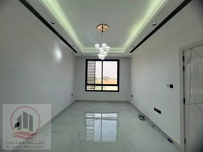 Villa for sale in Ajman, Al Helio area, including registration fees. 5 master bedrooms, majlis, living room, and maid's room. Freehold ownership.