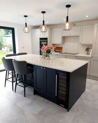 Modern kitchen island with white quartz top and built-in wine cooler