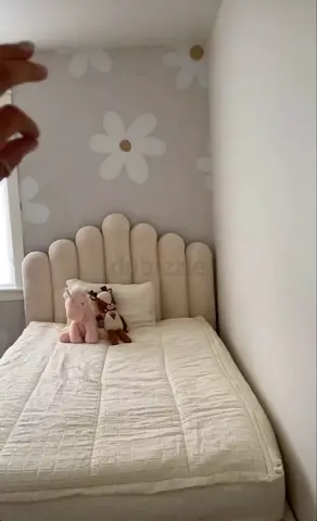 Single toddler/child bed with plush toys and padded headboard