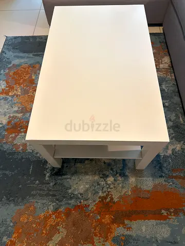 Simple white rectangular side table with open shelf — good condition and carpet
