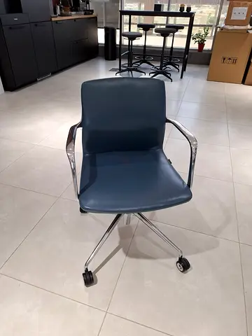 Used blue leather office chair with wheels and chrome frame