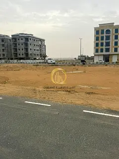 Residential/commercial land for sale in Telal City, prime location on Street 24, second plot from th