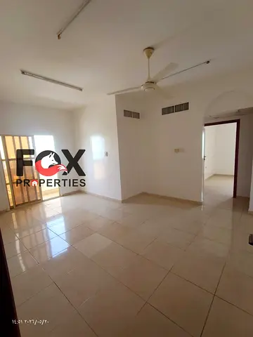 Two bedrooms and a living room for annual rent in Al Nuaimiya 3, behind City Tower and Al Safeer Mall, with a balcony and two bathrooms.