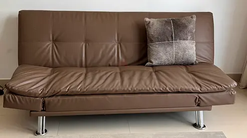 Brown leather foldable sofa bed — good condition