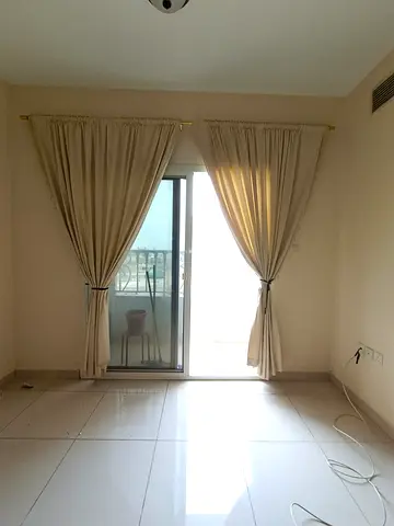 For annual rent in cooperation with Sharjah Two-bedroom apartment with a living room and a balcony