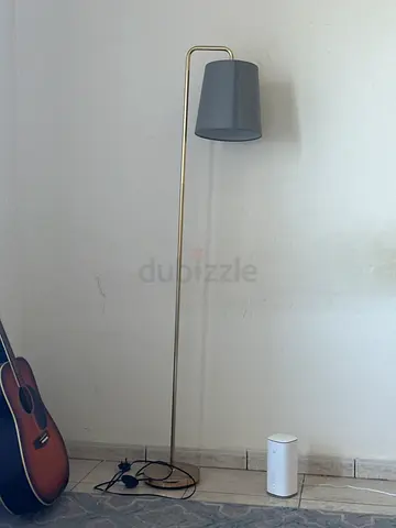 Slim brass floor lamp with grey fabric shade - modern design