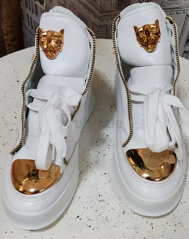 White high-top sneakers with gold accents and side zippers - gently used