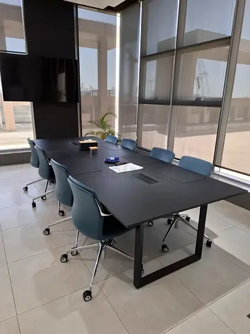 Modern black conference table with 6 swivel chairs — good condition