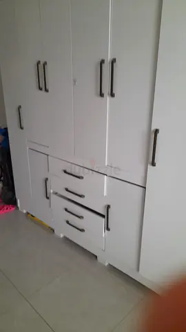 White built-in cabinet with multiple drawers and handles - good condition