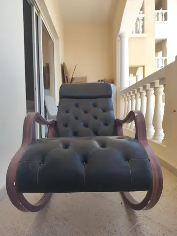 Classic tufted leather rocking armchair with wooden frame