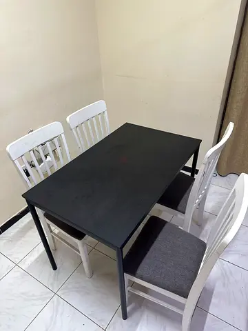IKEA Small black dining table with 4 white chairs - good condition