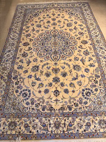 Handmade Persian-style cream and blue floral rug