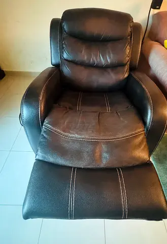 Used black leather recliner armchair with footrest
