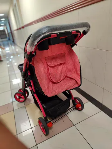 Lightweight pink baby stroller with cup holder