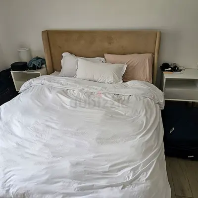 King-size upholstered bed with headboard and bedside shelves
