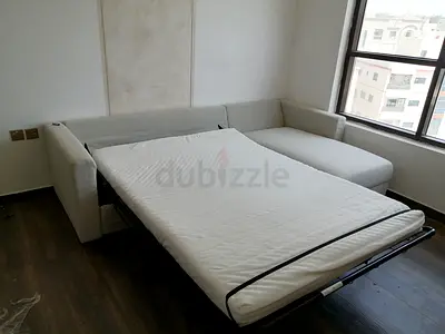 Beige L-shaped sofa bed with pull-out mattress - Good condition