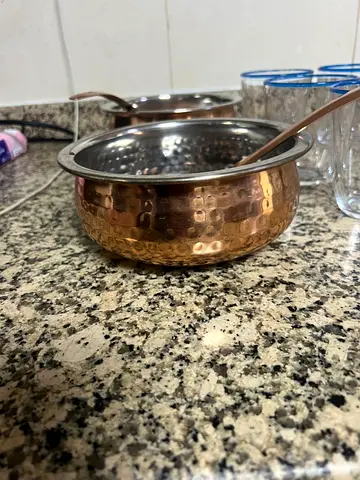 Set of small hammered copper serving bowls with spoons form pan home
