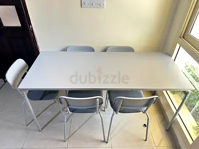IKEA-style white folding dining table with 5 grey chairs - good condition
