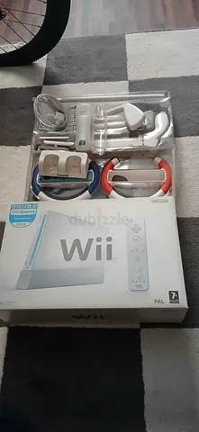 Nintendo Wii console bundle with controllers, golf stick, gun, and racing wheels