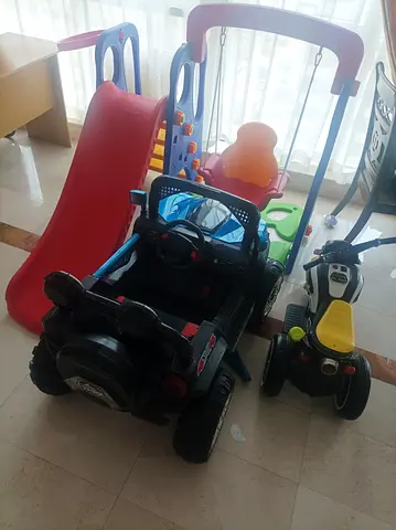 Kids indoor playset: slide, swing, ride-on car and trike – used but in good condition