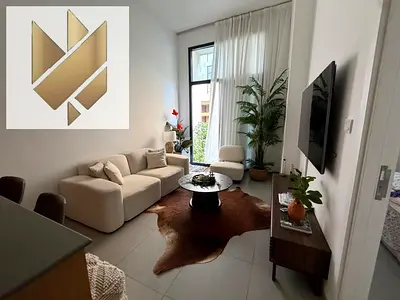 fully furnished one-bedroom apartment with a living room in Al Mamsha