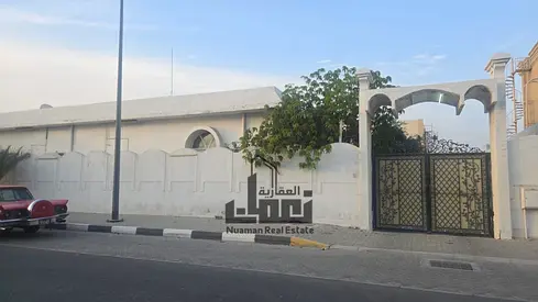 Villa for sale located in the Al Riffa area of Sharjah, featuring a generous land area of 11,449 Sq. Ft. The property is designed with a main residenc