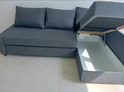 Grey L-shaped sofa with storage — good condition