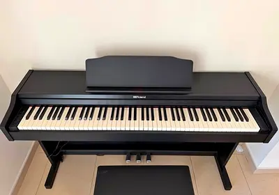 The Roland RP102 is an entry-level, space-saving digital home piano featuring 88 weighted keys