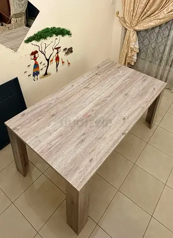 Solid wood-look dining table in light oak finish - good condition